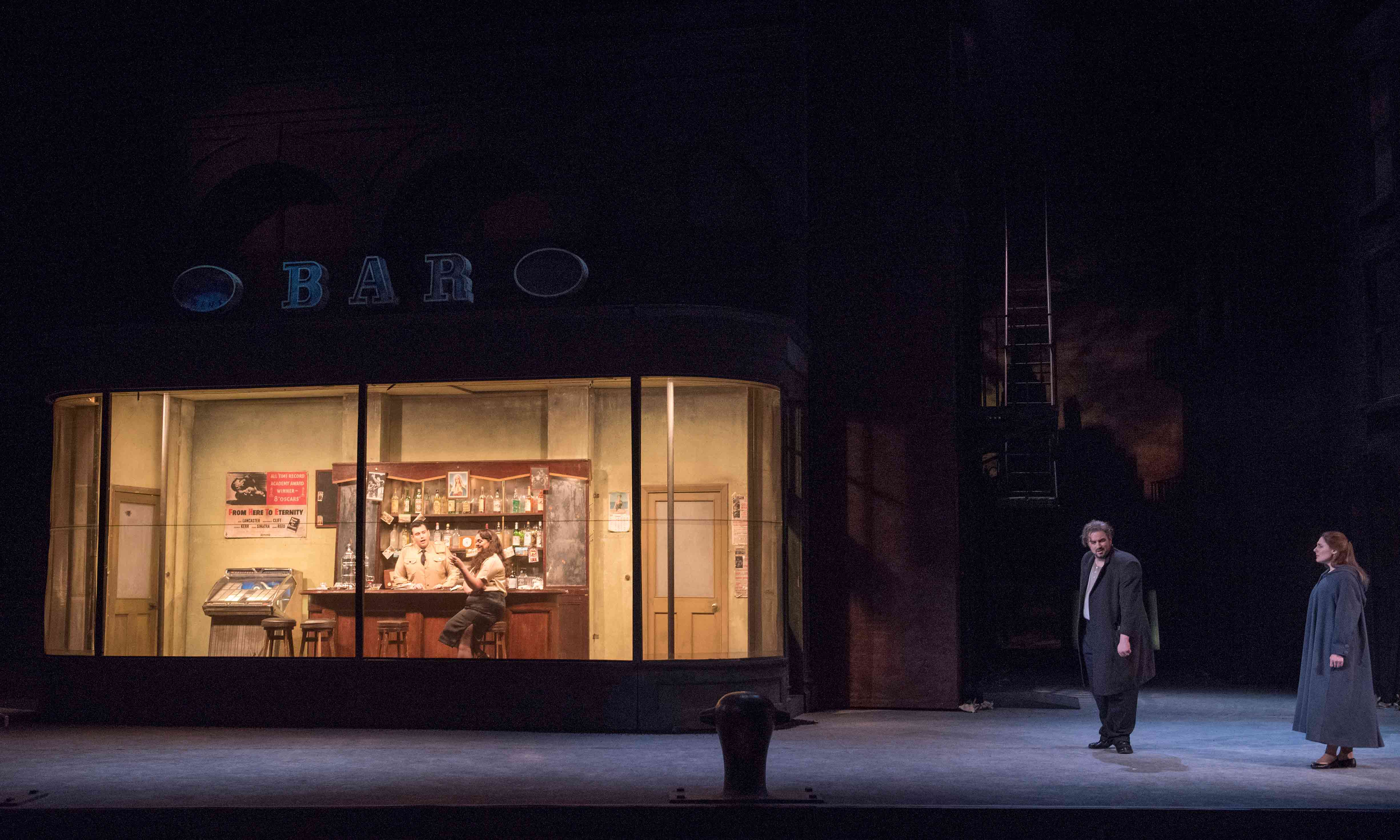 Man standing outside a bar looking in