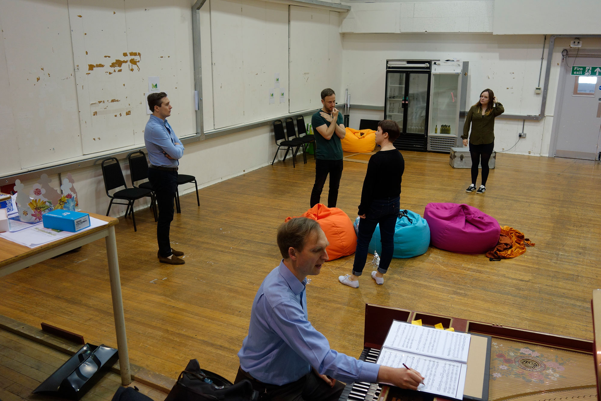 Acis and Galatea - Nicholas Ansdell-Evans makes notes while Alexander Sprague, Bradley Smith, and Lucy Hall rehearse