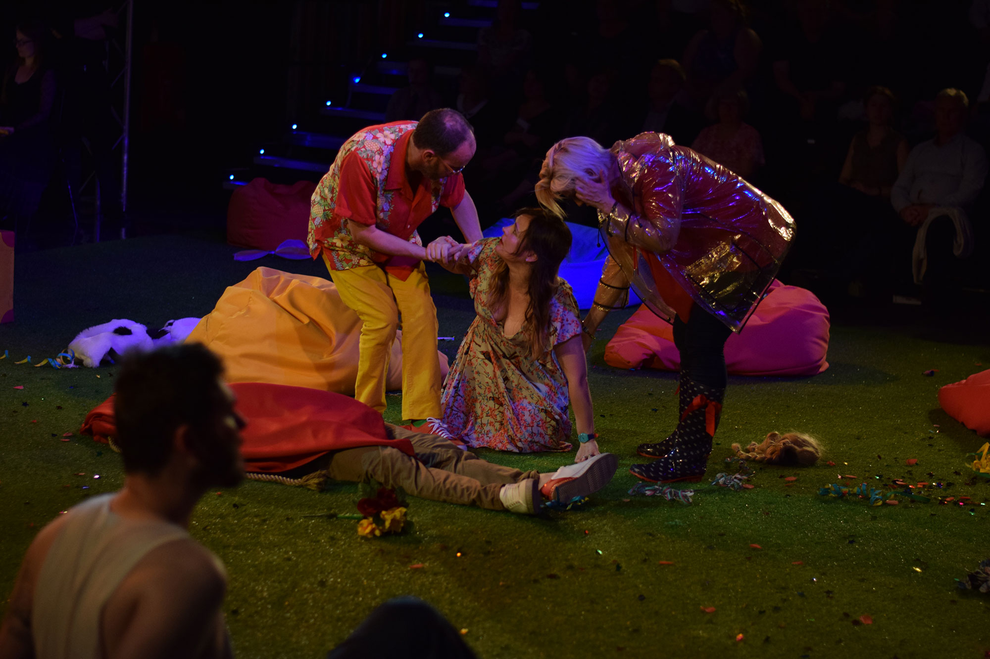 Scene with actors on the floor and being pulled up by others