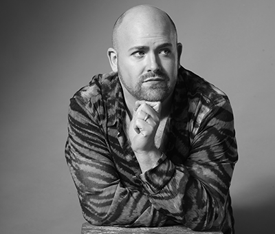 Black and white headshot of Nicky Spence