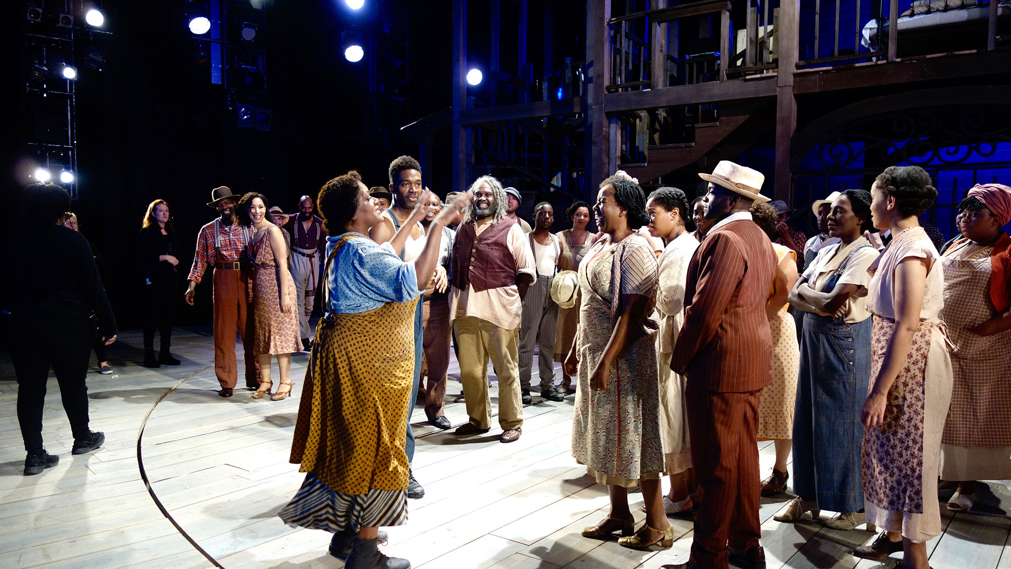 Tichina Vaughn (Maria) directs cast and ensemble into getting ready for a whole group picture