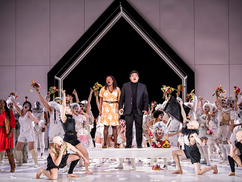 Couple standing on a table surrounded by dancers