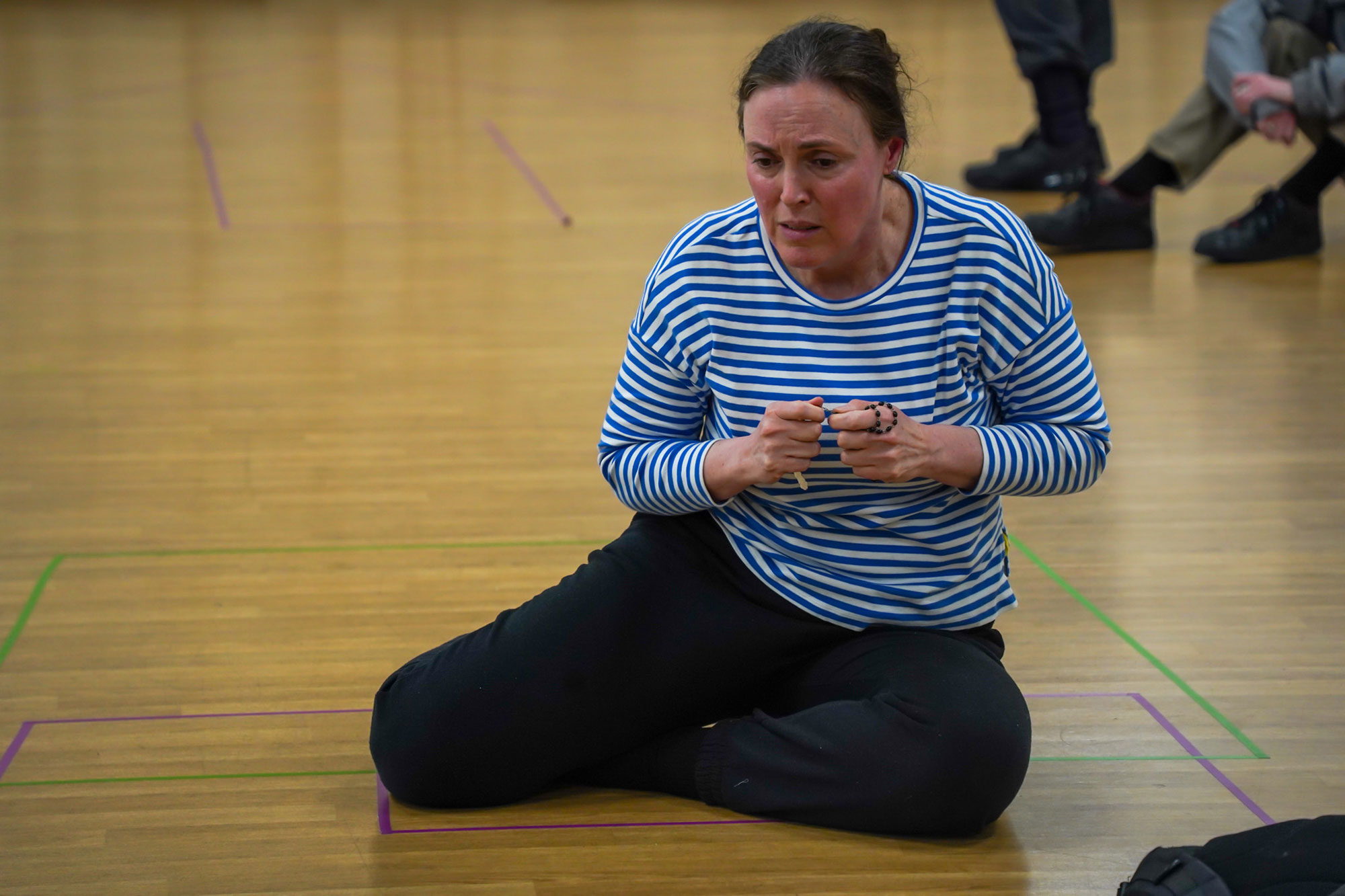 Rehearsal Images of Nicole Chevalier sitting on the floor